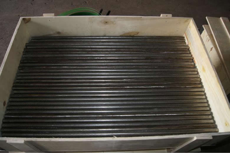Many stainless steel perforated filter tubes are placed in wooden carton